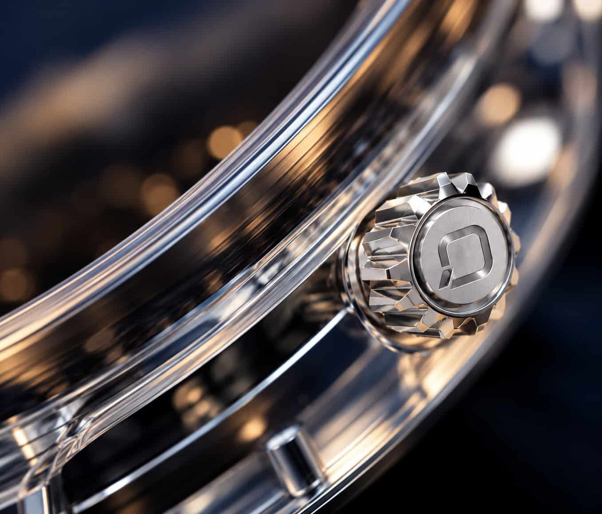 Close-up of a shiny metallic drum shell and a silver decorative lug nut on a dark, blurred background.