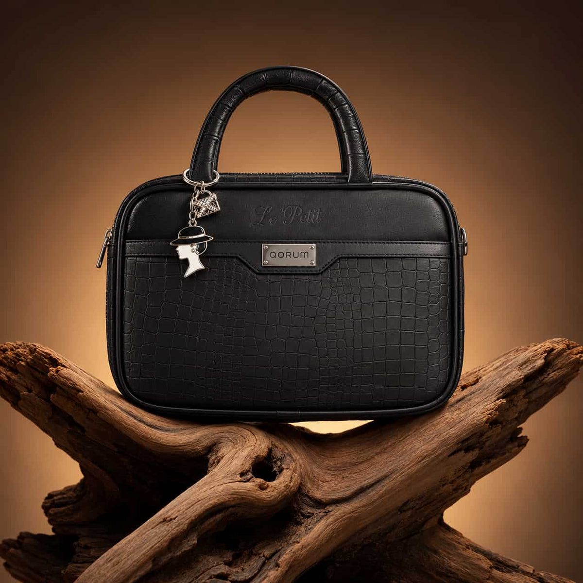 A black crocodile-embossed leather briefcase-style handbag with a top handle, silver-tone hardware.