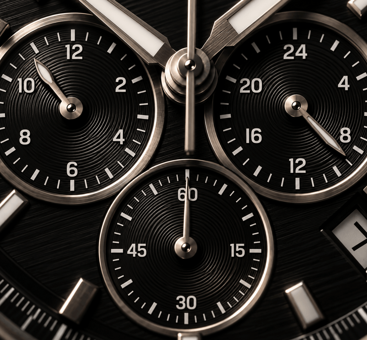 Close-up of a black chronograph watch face with three circular subdials, silver-tone bezels, and white numerals.